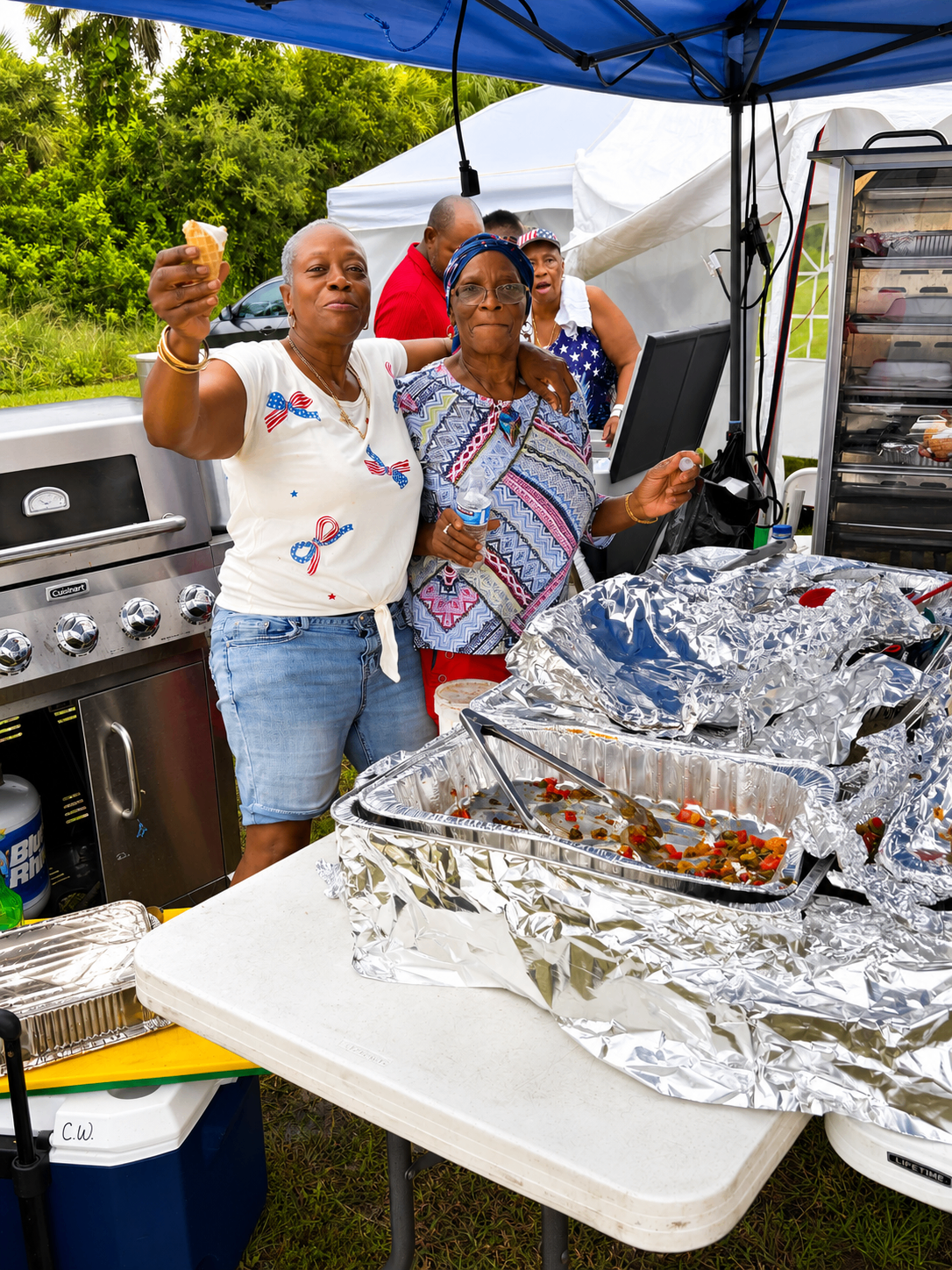 Members serving food at a community cookout