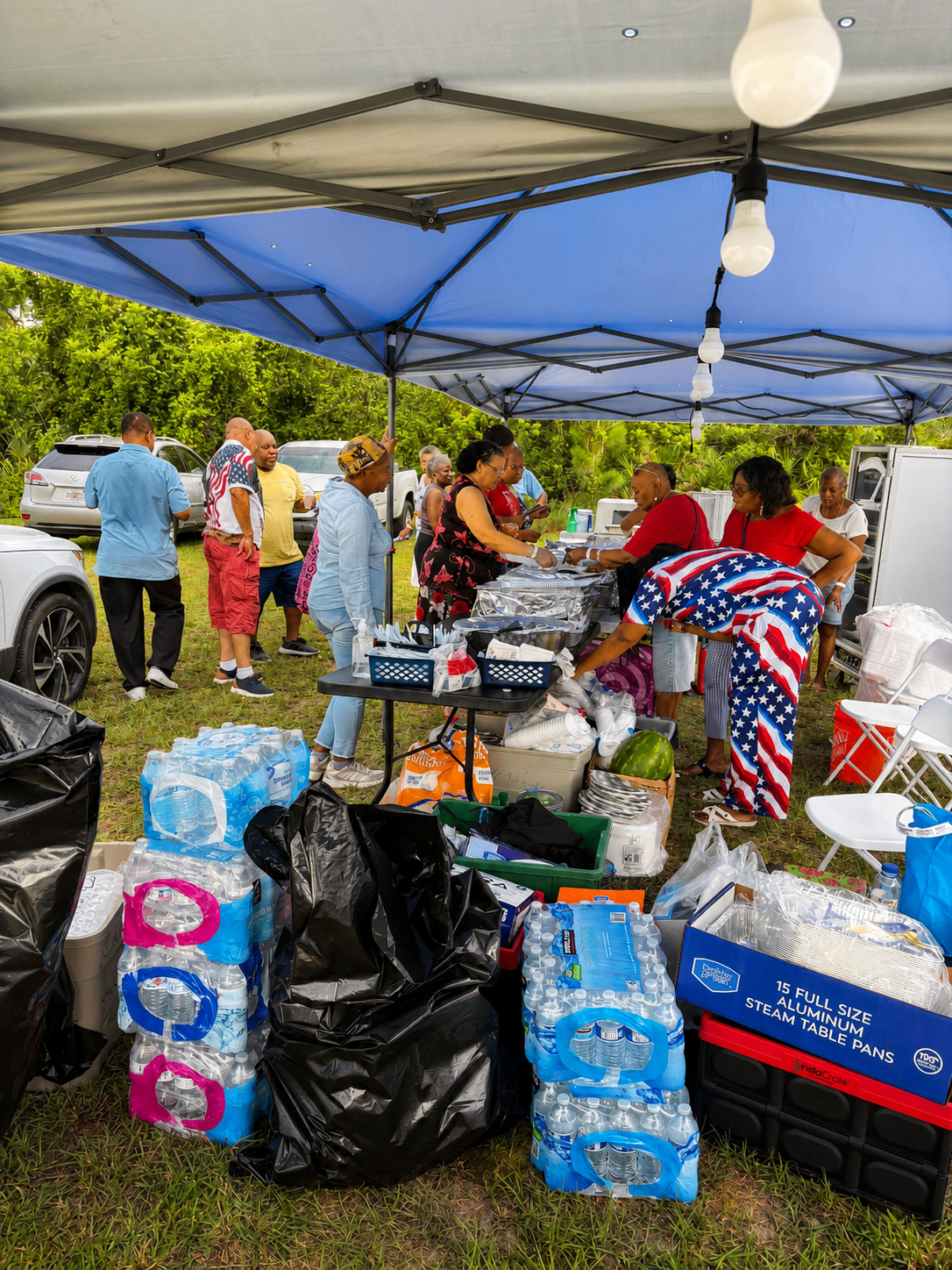 Members setting up a community food and supply tent