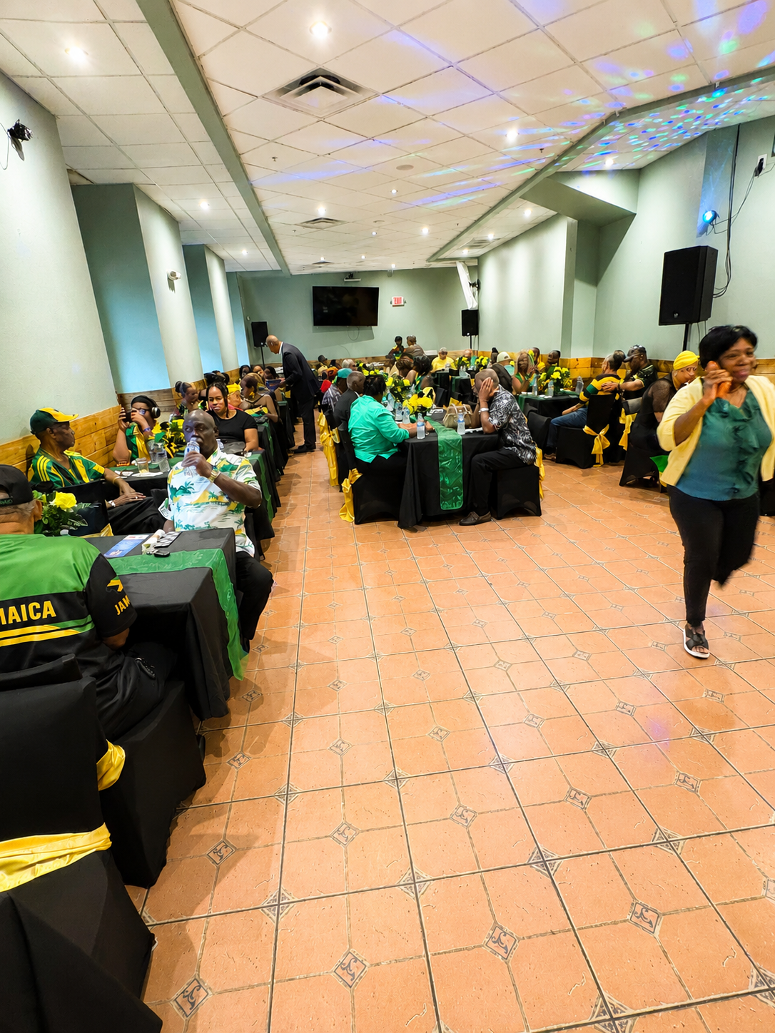 Wide view of the event hall with guests and dance floor