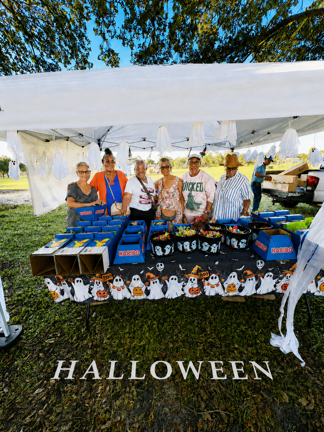 Lehigh Cavaliers members at the Halloween candy booth in the park